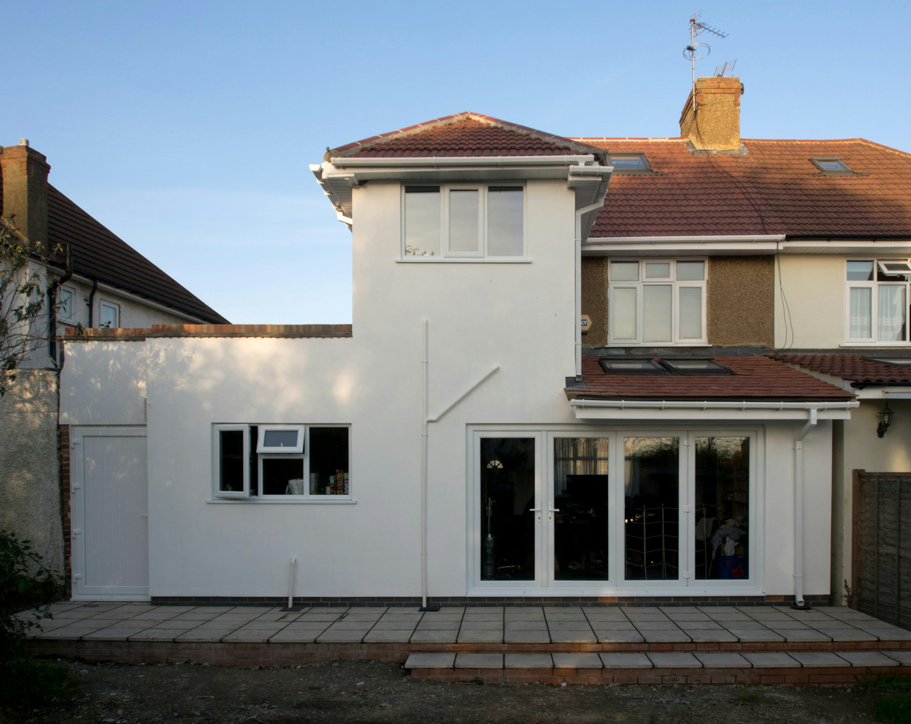 Completed rendered rear extension with garden-facing glazing